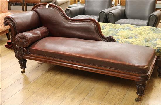 An early Victorian mahogany framed chaise longue, on reeded turned and tapering legs with brass feet and W.6ft 2in.